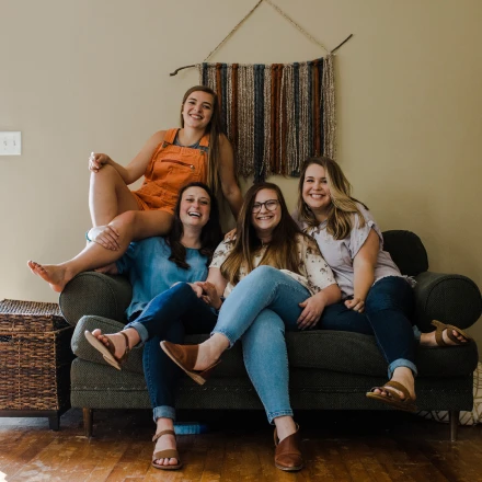 Roommates relaxing together on a couch in a shared living room